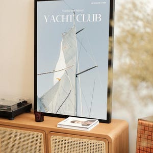 May include: A framed poster with a sailboat and the text "Nantucket Island Yacht Club" and "Summer 1984".
