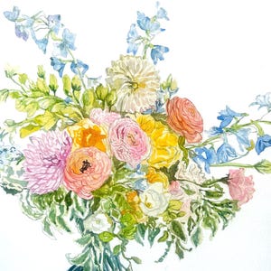 May include: A watercolor painting of a floral bouquet featuring pink, orange, and yellow ranunculus, a white dahlia, and light blue delphinium flowers with green foliage. The stems are gathered at the bottom in a dark blue painted brushstroke.