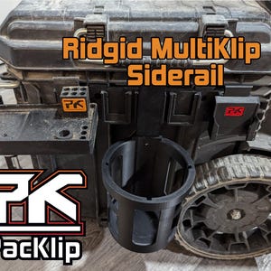 May include: A black Ridgid MultiKlip Siderail toolbox with a black PackKlip cup holder and a black tray with a PackKlip logo. The toolbox has a black wheel and a black handle.