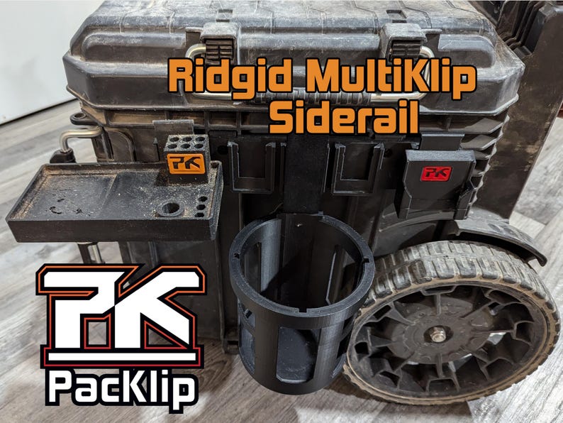 May include: A black Ridgid MultiKlip Siderail toolbox with a black PackKlip cup holder and a black tray with a PackKlip logo. The toolbox has a black wheel and a black handle.