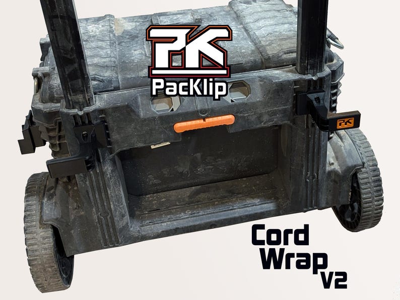 May include: Black rolling tool box with the text "Cord Wrap v2". The tool box has an orange handle and black wheels. The logo "PK Packclip" is visible on the top of the tool box.