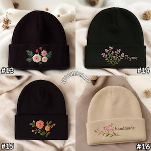 May include: Four beanies with floral embroidery. The beanies are black, dark green, and beige. One black beanie has the word "Thyme" embroidered. Another beige beanie has the word "handmade" embroidered. The beanies are a winter accessory.