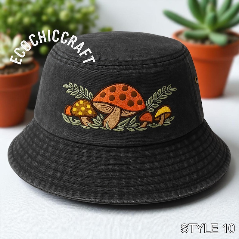 May include: A charcoal gray bucket hat featuring an embroidered design of various mushrooms in orange, yellow, and brown tones with green leaves. The text ECOCHICCRAFT is arched above the embroidery, and the text STYLE 10 appears at the bottom right.