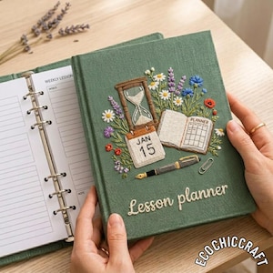 May include: A sage green fabric-covered lesson planner featuring intricate embroidery of an hourglass, a calendar page marked JAN 15, an open book, a fountain pen, a paperclip, and colourful wildflowers. The words Lesson planner are embroidered.