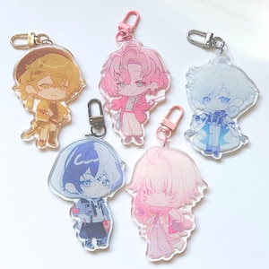 May include: Six colorful anime character keychains with different colored hair and clothing. The keychains are made of clear acrylic and feature detailed illustrations of the characters.