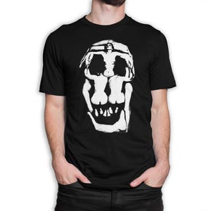 May include: A black t-shirt with a white graphic of a skull made up of two figures. The figures are in a pose that creates the illusion of a skull.