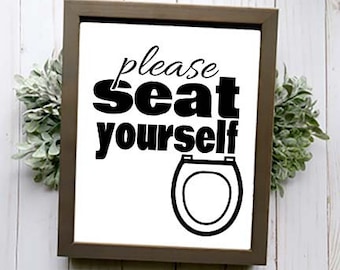 May include: A brown wooden framed sign with white background and black text that reads "Please seat yourself" with a black silhouette of a toilet seat.
