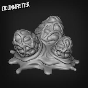 Puede incluir: Un modelo impreso en 3D de una criatura gris, orgánica, con forma de blob y una superficie texturizada. La criatura tiene tres protuberancias redondeadas y abultadas en la parte superior.