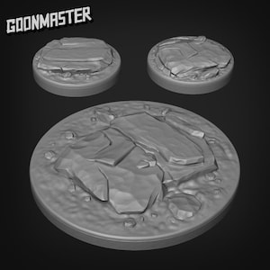 May include: Three gray, round, textured, miniature bases for tabletop gaming. The bases feature a rocky, uneven surface.