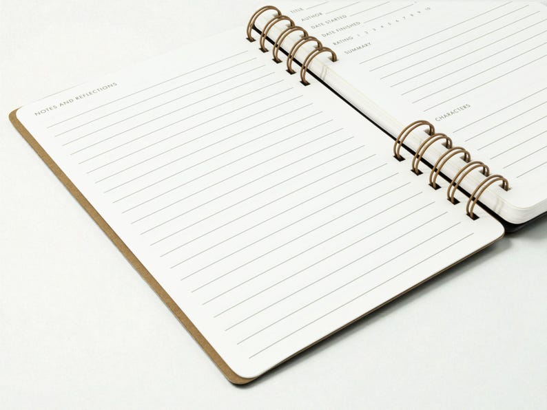 Alternate angled view of reading journal open to a full spread, showing the notes and reflections page in the foreground and the book details page in the background. Dual antique brass wire binding is visible.