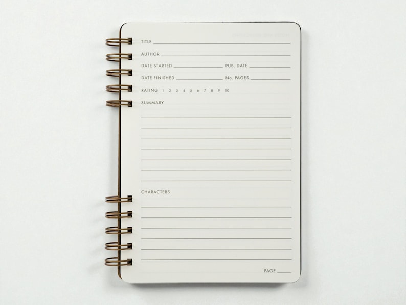 Interior spread of the reading journal showing the structured book review layout, including fields for title, author, publication date, start and finish dates, page count, rating scale from 1 to 10, summary section, and characters section. Journal is photographed open against a clean white background.