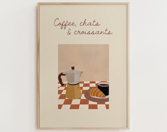 May include: A framed print featuring a coffee-themed illustration. The artwork depicts a yellow and silver stovetop espresso maker, a black coffee cup, and a croissant on a plate, set on a red and white checkered surface. The text "Coffee, chats & croissants" is written at the top.