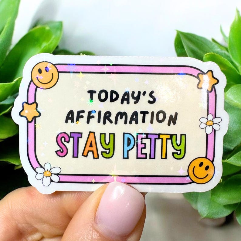 May include: A rectangular sticker with a pink border and the text "TODAY'S AFFIRMATION STAY PETTY" in colorful letters. The sticker features smiley faces, stars, and daisies.