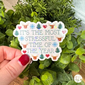 A holographic version of the “It’s the Most Stressful Time of the Year” holiday sticker with a shimmering rainbow finish. The cross-stitch inspired design features tiny pixel reindeer, trees, and snowflakes that sparkle as the light moves. Ideal for holiday gifting, stocking stuffers, or adding humor to your laptop, tumbler, or journal. Waterproof and handmade, available in a holographic finish.