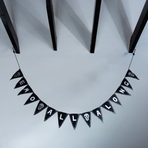 May include: Black and white Halloween banner with the words "EMO ALL ALONG" and skull designs.