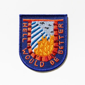 May include: A blue and orange embroidered patch with the text "Hell would be better". The patch features a stylized image of flames and a blue and white striped pattern.