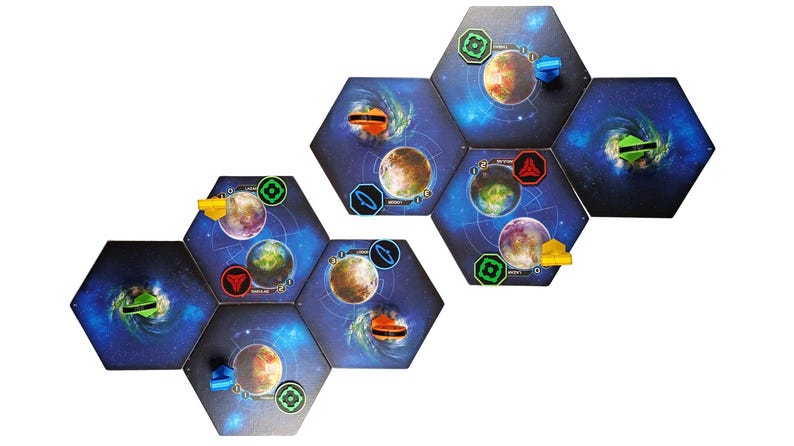 May include: A set of hexagonal board game tiles featuring space-themed illustrations of planets, nebulae, and stars. The tiles are arranged in two clusters and include various small plastic markers in red, blue, yellow, and green colors.