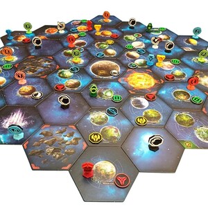 May include: A board game setup featuring a large hexagonal grid of space-themed tiles. The tiles display various planets, stars, and nebulae in shades of blue, orange, and black. Small colored plastic tokens and markers are placed on the tiles.