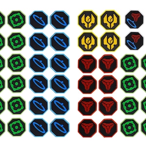 May include: A collection of small octagonal tokens arranged in rows and columns. The tokens feature black backgrounds with various graphic symbols in red, green, blue, and yellow, including stylized shapes, rings, and geometric patterns.