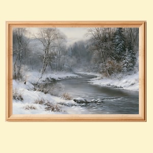 May include: A framed landscape painting depicting a winter scene with a flowing river surrounded by snow-covered banks, bare trees, and evergreen pines under a soft, overcast sky. The artwork is enclosed in a light-toned wooden frame.