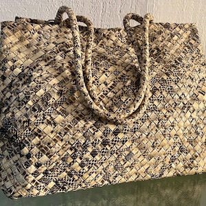 May include: A set of three ceramic mugs with a speckled, matte finish. The mugs are in shades of cream, light gray, and dark gray. Each mug has a simple, minimalist design and a rounded handle.