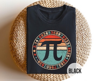 May include: Black t-shirt with a vintage-style graphic of the mathematical constant pi, surrounded by the digits of pi. The graphic has a red, orange, yellow, and blue color scheme.