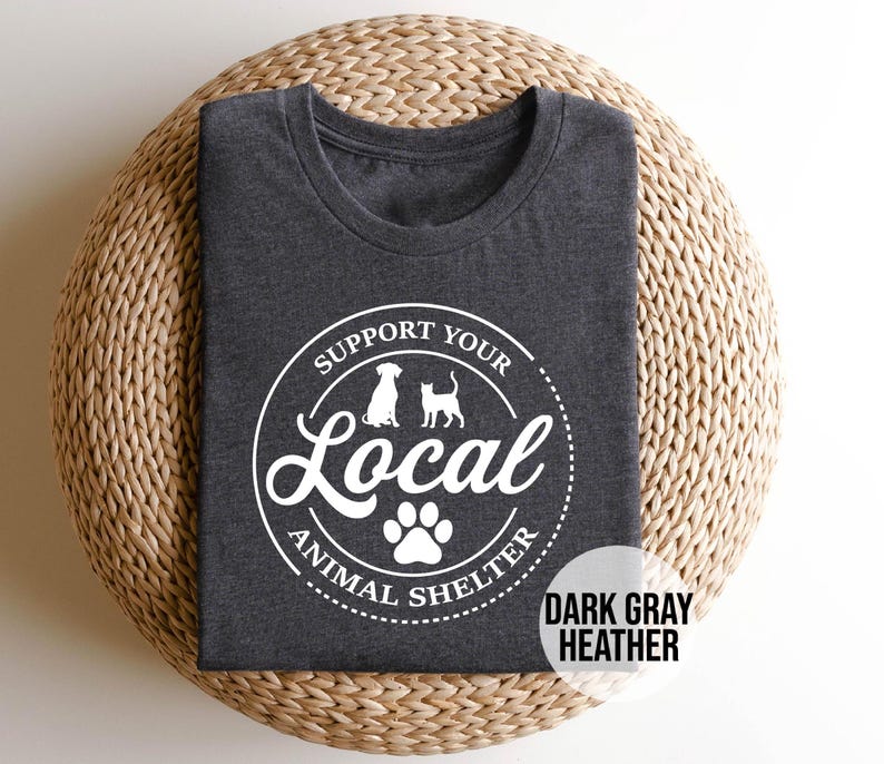 May include: Dark gray heather t-shirt with a white circle graphic that says "Support Your Local Animal Shelter" with a paw print and silhouettes of a dog and cat.