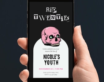 May include: A black smartphone screen displays a pink skull with green eyes and the text "Rip Twenties" in black and white. The text below reads "Come and join us as we mourn the loss of Nicole's Youth" with the words "Nicole's Youth" in pink dripping letters. The date and time are listed as "November 22 | 7:00 PM" and the location is "The Goth Bar, NYC". The RSVP number is "123-456-7890".