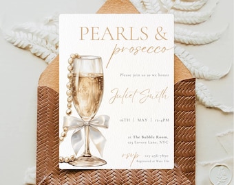 May include: An invitation card with the text "PEARLS & prosecco" and event details. The design features a champagne glass with a pearl necklace, a white bow, and a brown woven envelope. The invitation is for Juliet Smith.