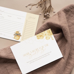 May include: Recipe cards and a "Share a Recipe" card with gold lettering are displayed on a mauve cloth. The recipe cards have a honey pot illustration. The "Share a Recipe" card has a honeycomb design.