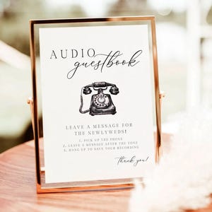 K&ouml;nnte beinhalten: Ein goldgerahmtes Schild mit dem Schriftzug "Audio Guestbook" in Schreibschrift. Eine Schwarz-Wei&szlig;-Illustration eines Vintage-Telefons ist abgebildet. Das Schild enth&auml;lt Anweisungen und endet mit "Thank you!"