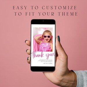 May include: A smartphone displays a pink-themed thank you card. The card features a photo of a young girl wearing sunglasses. The text "Thank you" is written in a cursive font. The background is a solid pink color.