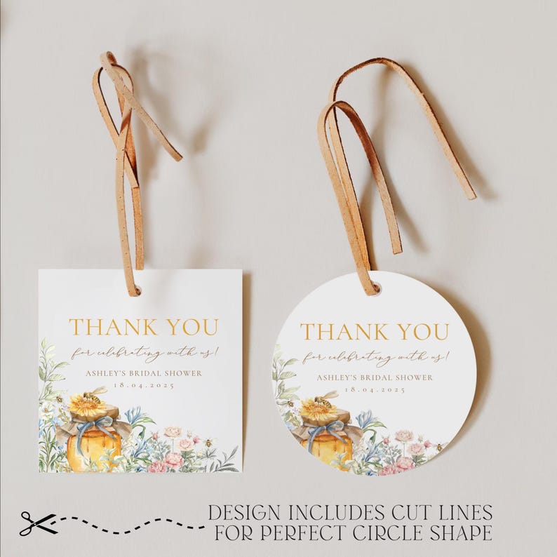 May include: Two white gift tags with brown leather string. One is square, the other is round. Both have gold text that reads "THANK YOU" and "Ashley's Bridal Shower 18.04.2025". Floral and honey jar illustrations decorate the tags.