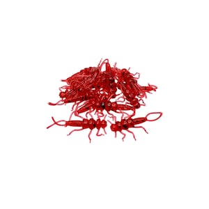 May include: A pile of red rubber fishing lures shaped like insects. The lures are designed to mimic aquatic insects and attract fish.
