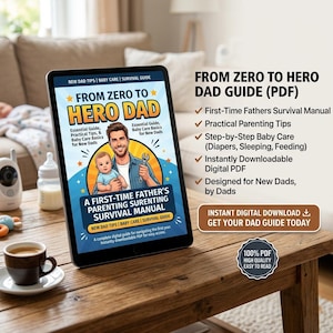 May include: A digital tablet displays a guide titled "From Zero to Hero Dad." The cover art features a father holding a baby. Text includes "First-Time Fathers Survival Manual" and "Instant Digital Download." A cup of coffee sits on a wooden table.
