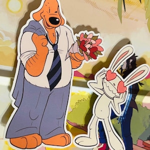 May include: Cartoon sticker featuring a dog-like character in a suit holding flowers, and a rabbit character with heart-shaped eyes. The dog is orange and white, and the rabbit is white. The background has a cartoonish landscape.