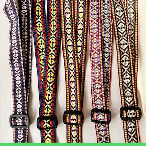 May include: Five colorful woven straps with geometric patterns and black plastic buckles. The straps feature designs in red, blue, yellow, and white. Each strap is labeled with a number from #1 to #5.