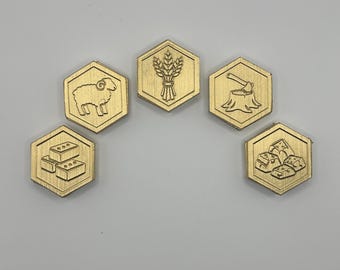 May include: Five gold-coloured hexagonal game tokens. Each token features a different embossed icon: a sheep, wheat, an axe chopping a tree stump, bricks, and a house. The tokens are arranged in an arc.
