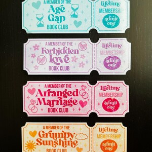 May include: Four colourful ticket-shaped stickers with text. Each ticket is divided into two sections. The left side has the text "A Member of the" followed by a book club name. The right side says "Lifetime Membership" and "Admit One."