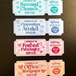 May include: Four colourful book club membership tickets. Each ticket features a different book club name: "Second Chance," "Opposites Attract," "Forced Proximity," and "Office Romance." Each ticket also includes "Lifetime Membership" and "admit one."