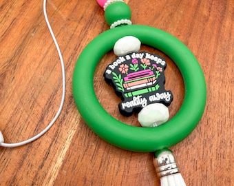 A Book a Day Keeps Reality Away Car Charm | Bookish Silicone Beaded Rearview Mirror Accessory | Green & Pink Reader Gift