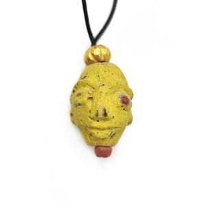 Old painted clay yellow head pendant, Indonesian old figure necklace pendant Sulawesi antiques