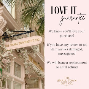 May include: Exterior shot of a pink building with a sign that reads "THE SMALL TOWN GIFT CO." The sign is hanging over a window with white flowers. The text "LOVE IT guarantee" is displayed on a pink background.