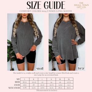 May include: A size guide for a Comfort Colors 6014 unisex long sleeve shirt. The image displays a charcoal grey long sleeve shirt in size small and large, with a table listing width, length, and sleeve length measurements in inches.