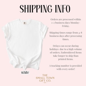 May include: A plain white short-sleeved t-shirt with a crew neckline. The garment is displayed flat against a light pink background. The word white is printed in black text below the shirt, and the brand name The Small Town Gift Co. is at the bottom.
