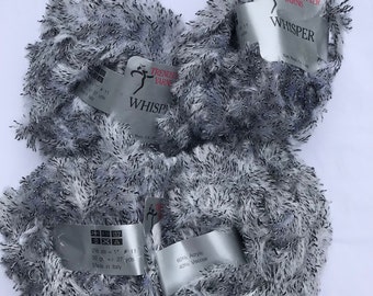 May include: Three skeins of gray and black fuzzy yarn labeled "Trendsetter Yarns Whisper" with the yarn composition listed as 60% Acrylic 40% Viscose. The yarn label also states "25 gs = 1" #11 50 g +/- 27 yds Made in Italy."