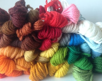 May include: A collection of embroidery floss spools in various colors, including brown, orange, yellow, green, blue, white, and pink.