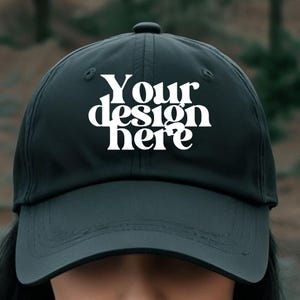 May include: A black baseball cap with a white design that says "Your design here".