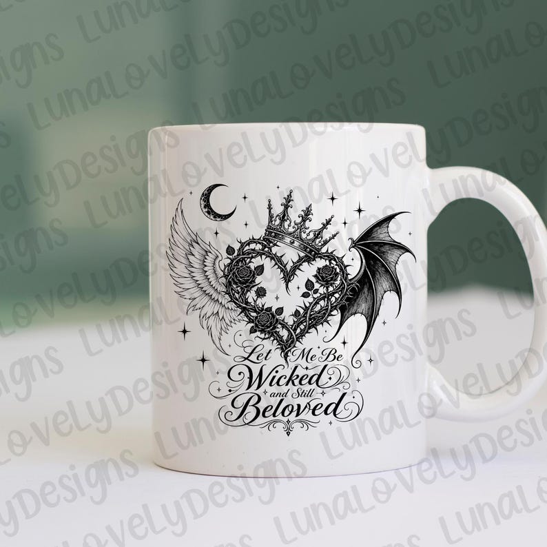 May include: White ceramic mug featuring a black and white heart design with a crown, wings, and the text "Let Me Be Wicked and Still Beloved." The design includes a crescent moon and stars, creating a gothic aesthetic.
