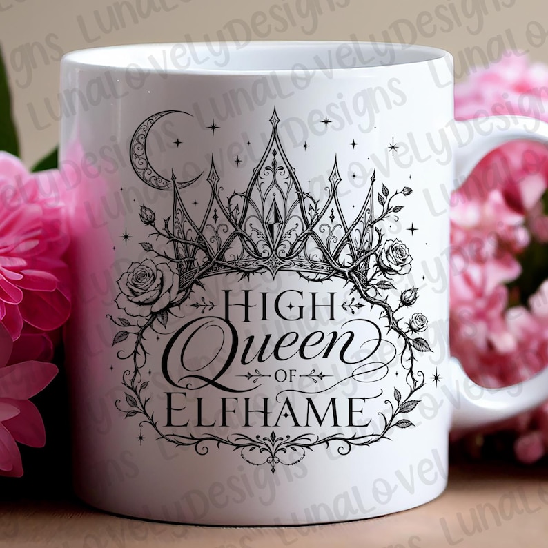 May include: White ceramic mug featuring a black illustration of a crown, roses, and the words "High Queen of Elfhame." The design includes a crescent moon and stars. The mug has a curved handle and is surrounded by pink flowers.